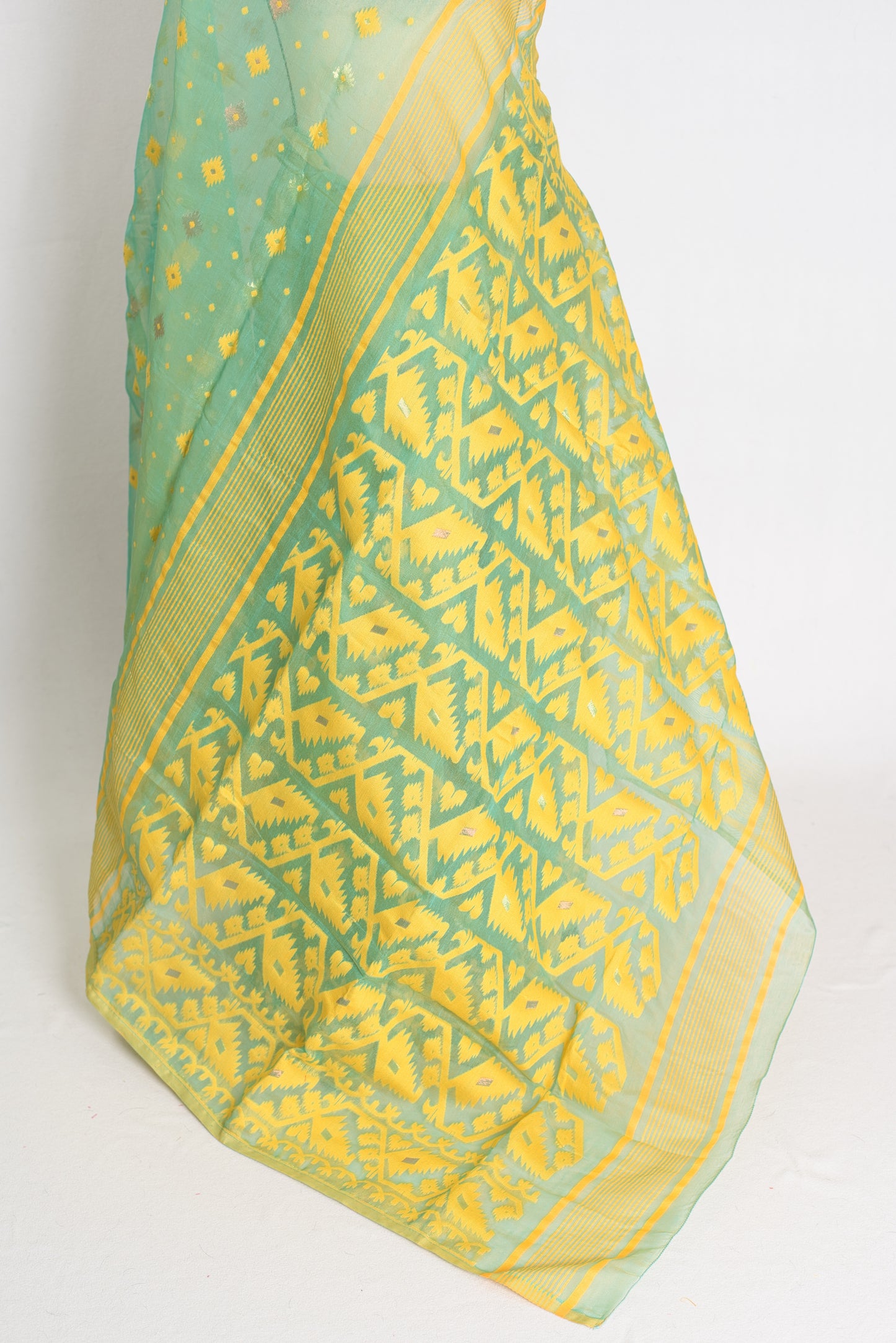 A refreshing sea green and yellow blended Jamdani saree in soft cotton, featuring traditional Bengali hand-loomed motifs and a delicate drape.