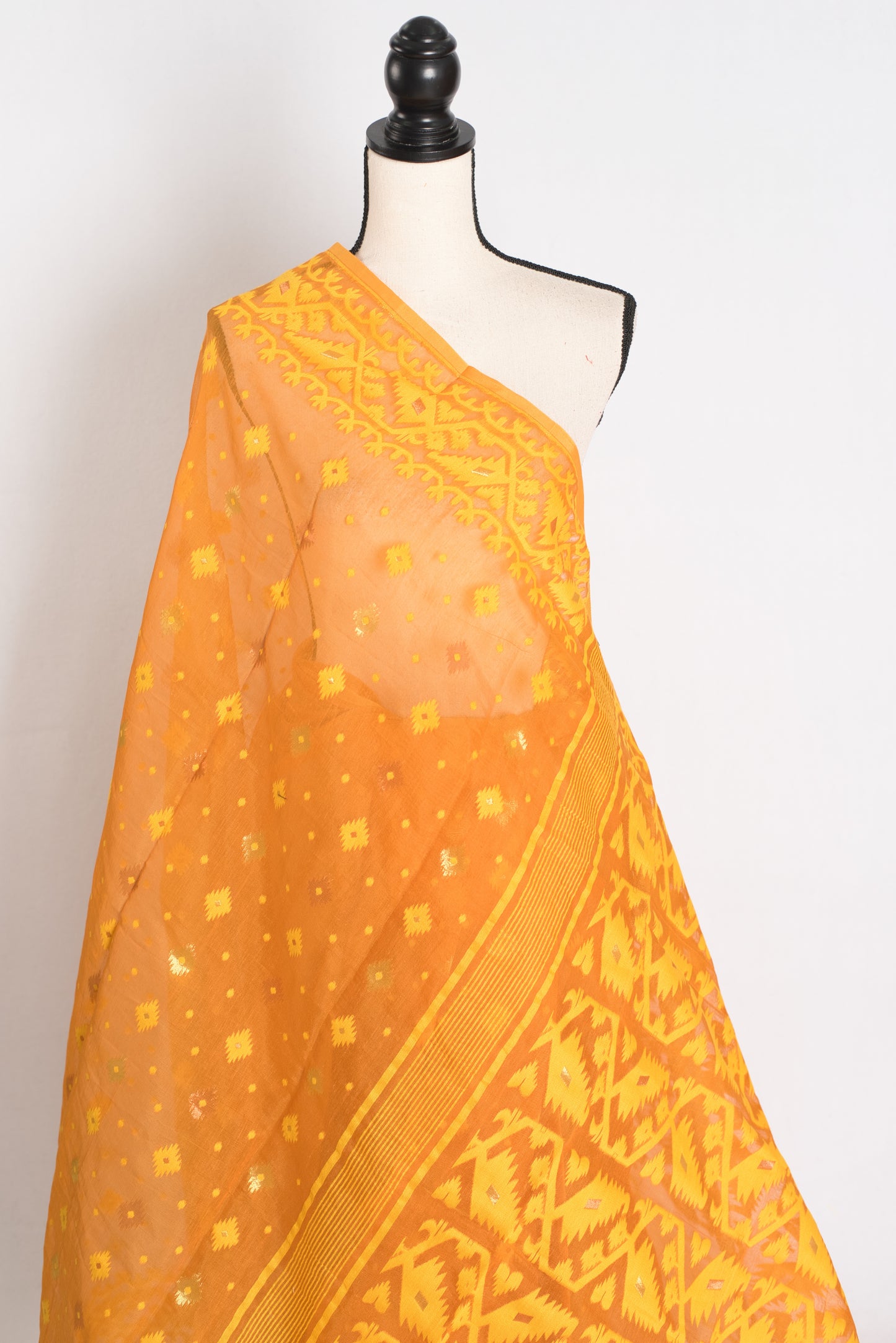 An earthy brown and yellow blended Jamdani saree in soft cotton, featuring traditional Bengali hand-loomed motifs and a sophisticated matte finish.