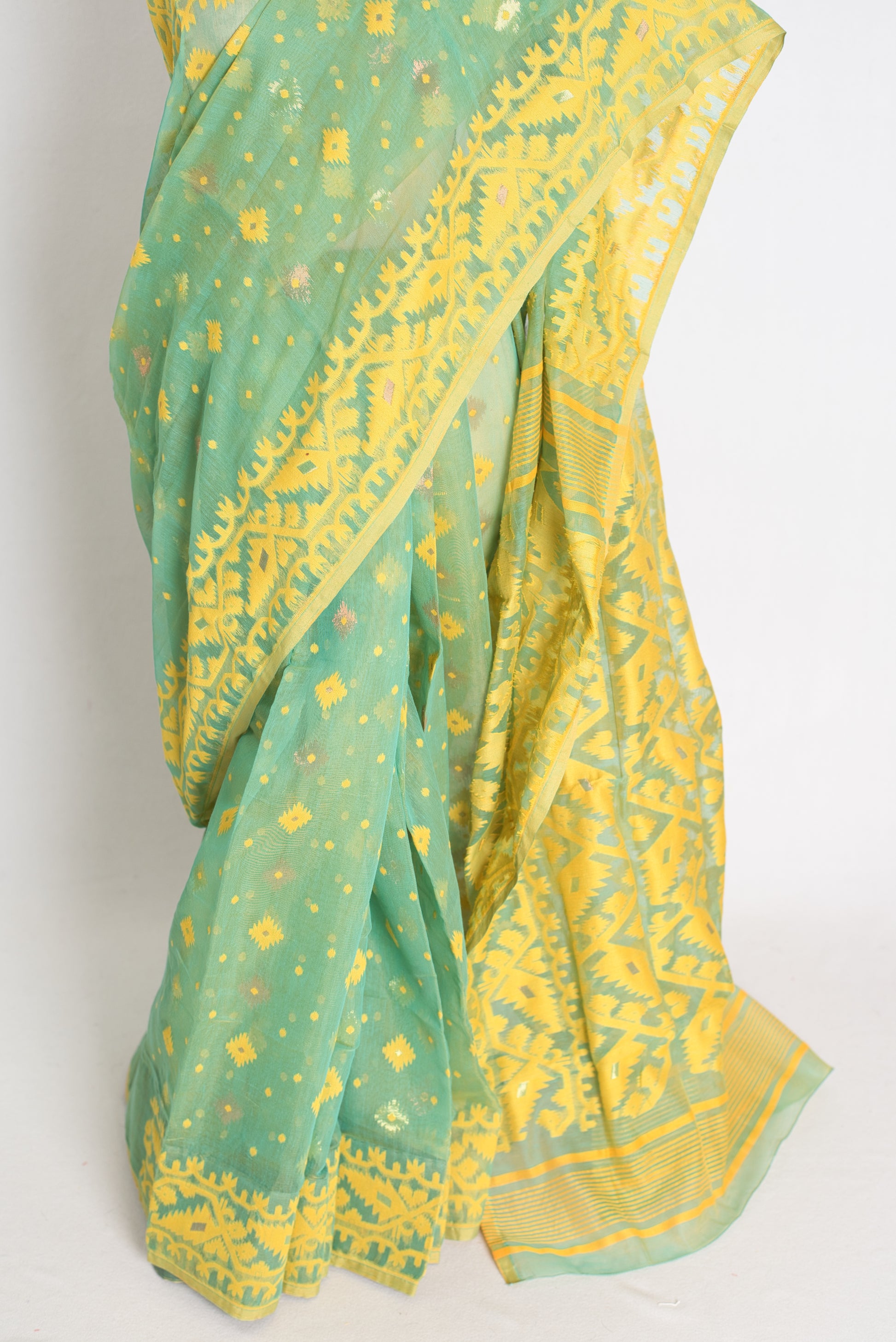 A refreshing sea green and yellow blended Jamdani saree in soft cotton, featuring traditional Bengali hand-loomed motifs and a delicate drape.