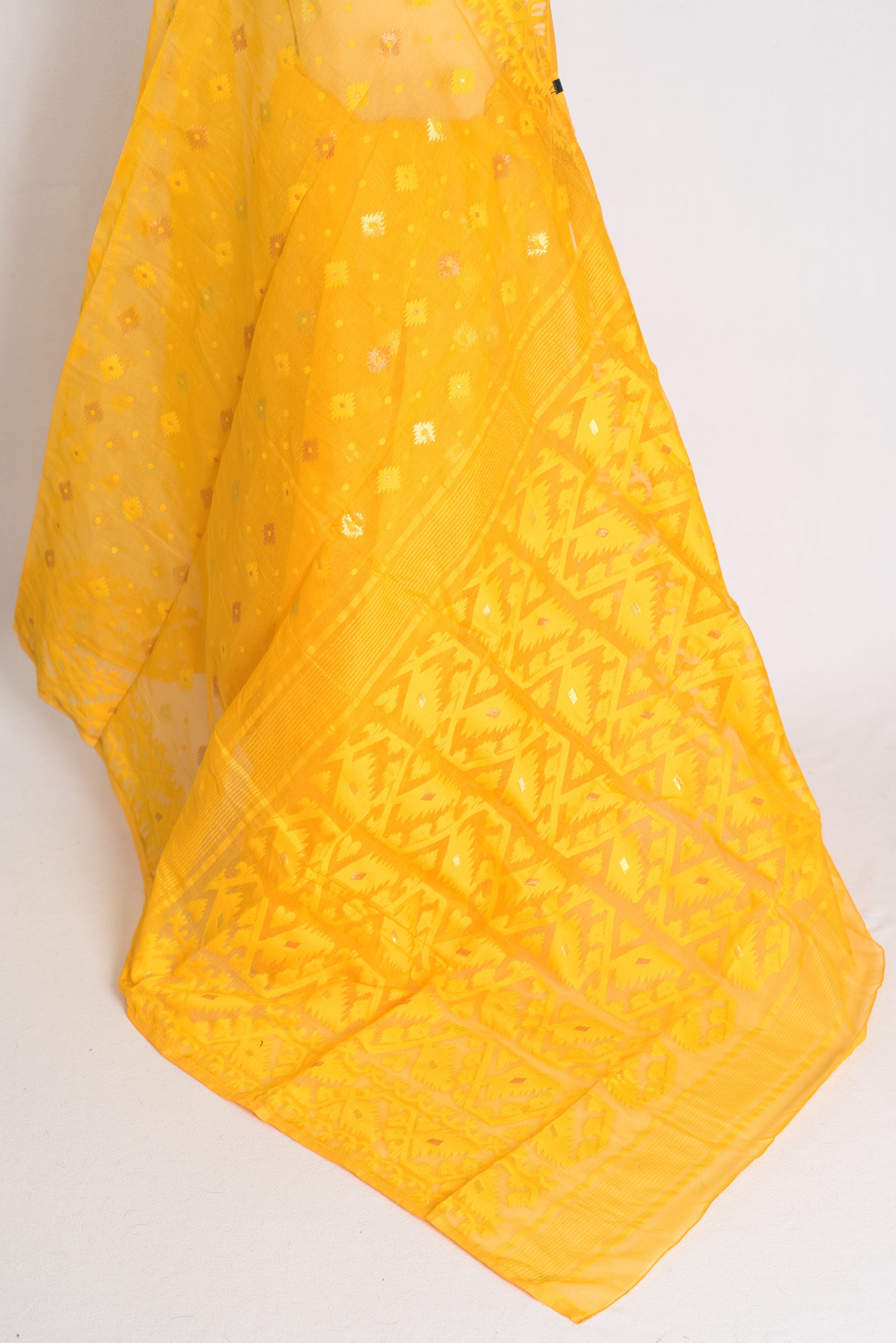 A vibrant deep yellow Bengali Jamdani saree crafted from a soft cotton blend, featuring traditional hand-loomed patterns perfect for festive occasions.