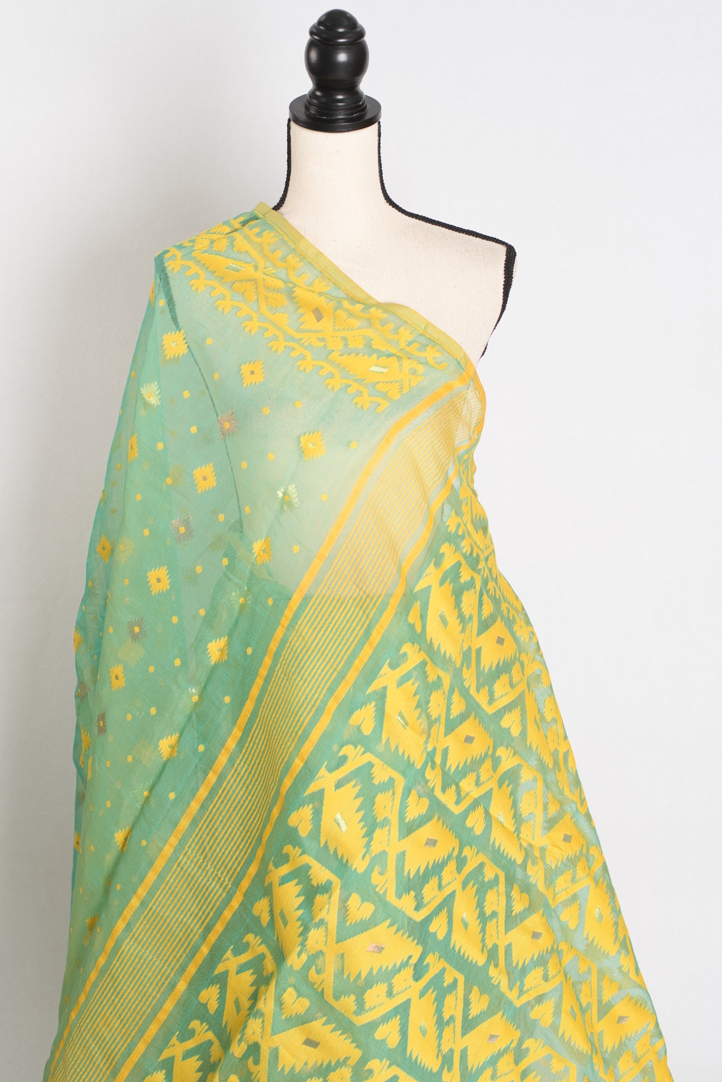 A refreshing sea green and yellow blended Jamdani saree in soft cotton, featuring traditional Bengali hand-loomed motifs and a delicate drape.