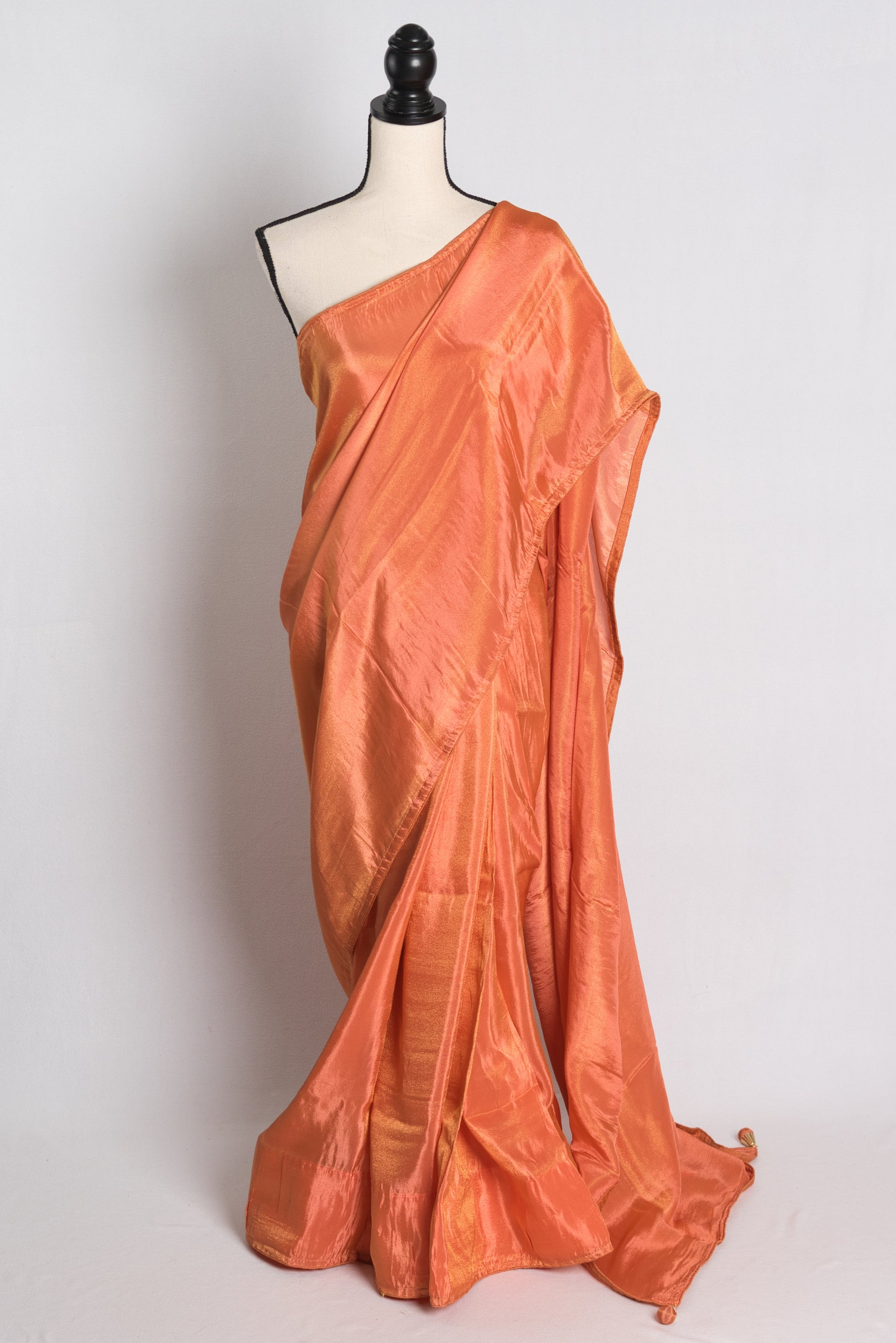 Soft Designer Tissue Saree in Orange with a Shimmer of Gold.