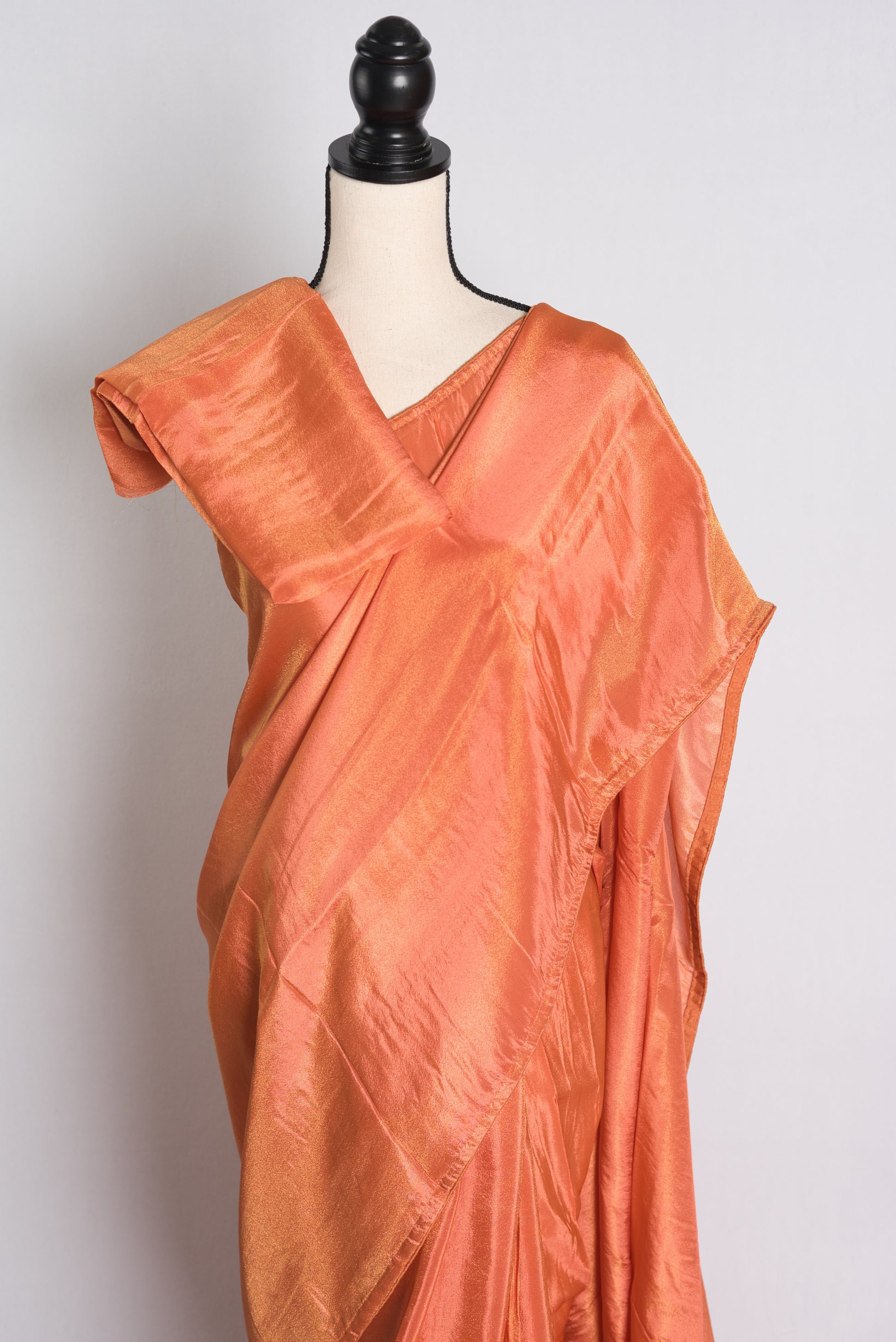 Soft Designer Tissue Saree in Orange with a Shimmer of Gold.