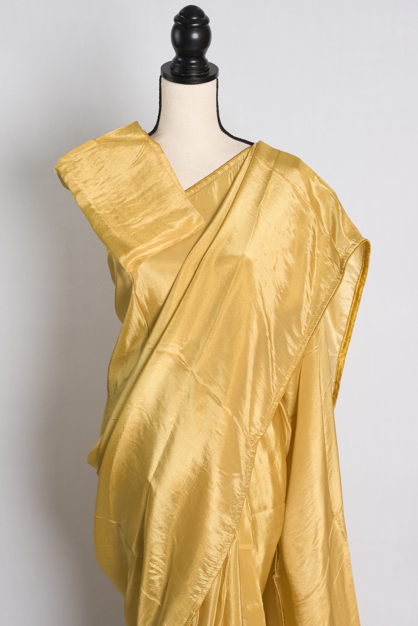 Soft Designer Tissue Saree in Gold.