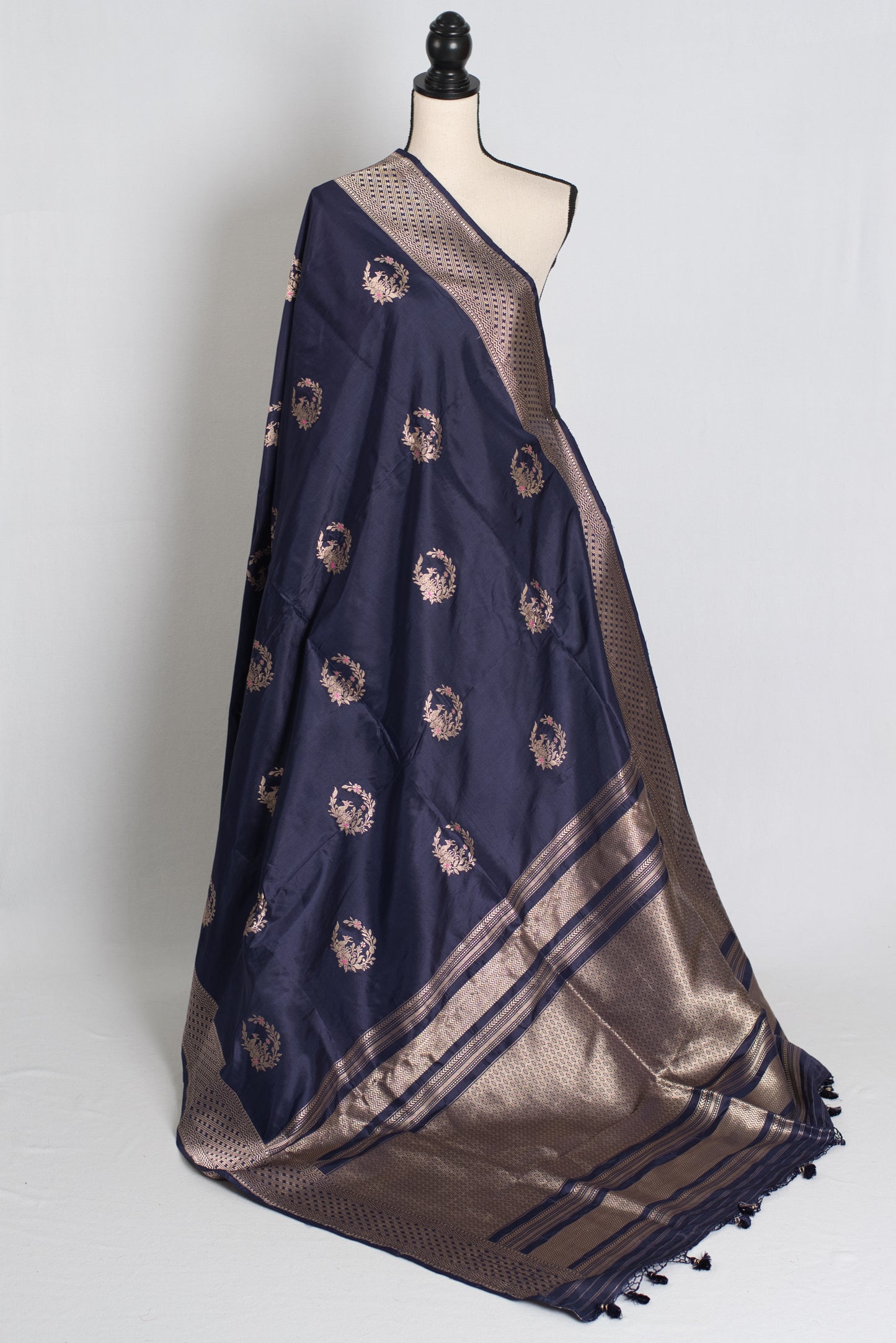 Navy blue and gold saree on a mannequin against a white background