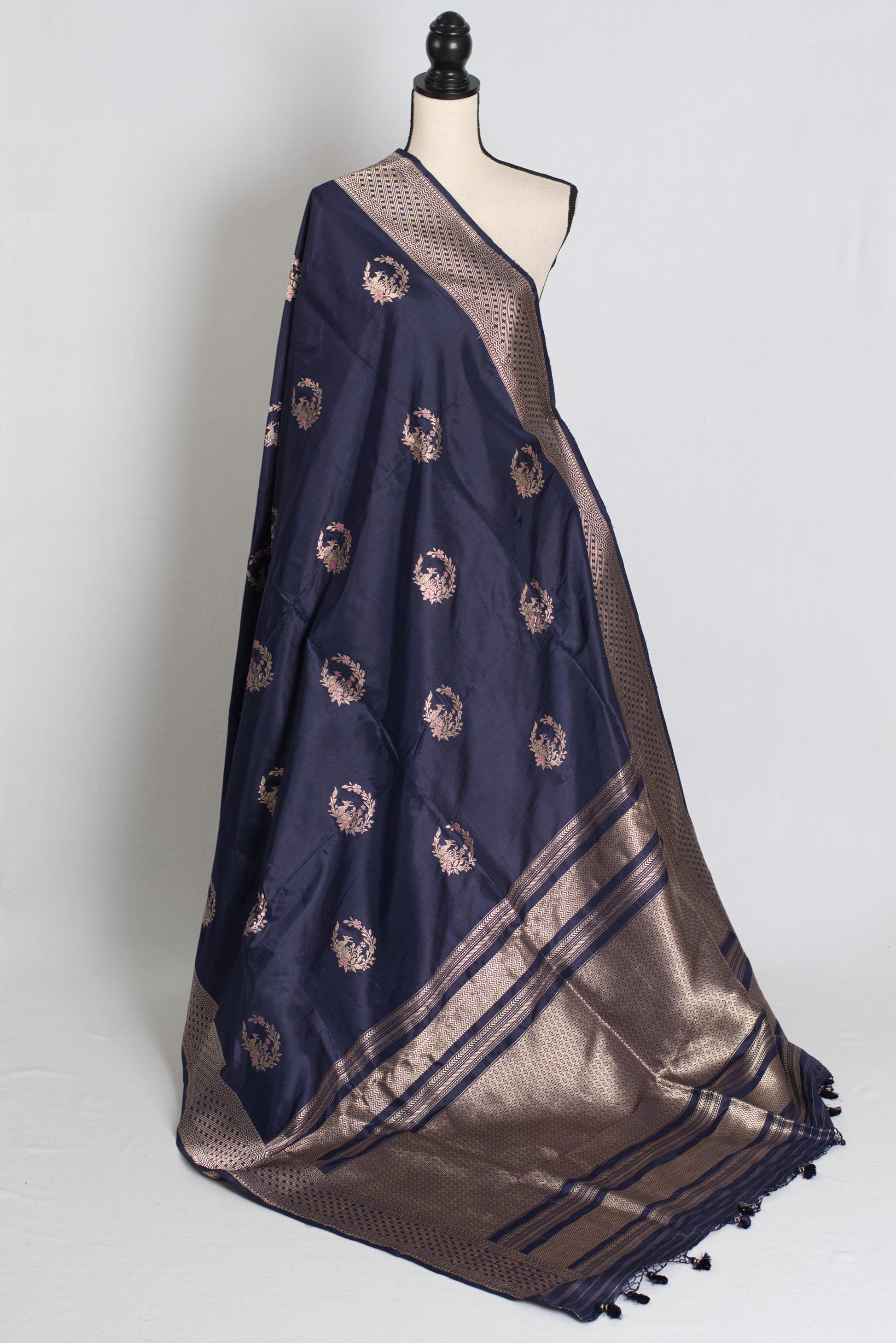 Navy blue and gold saree on a mannequin against a white background