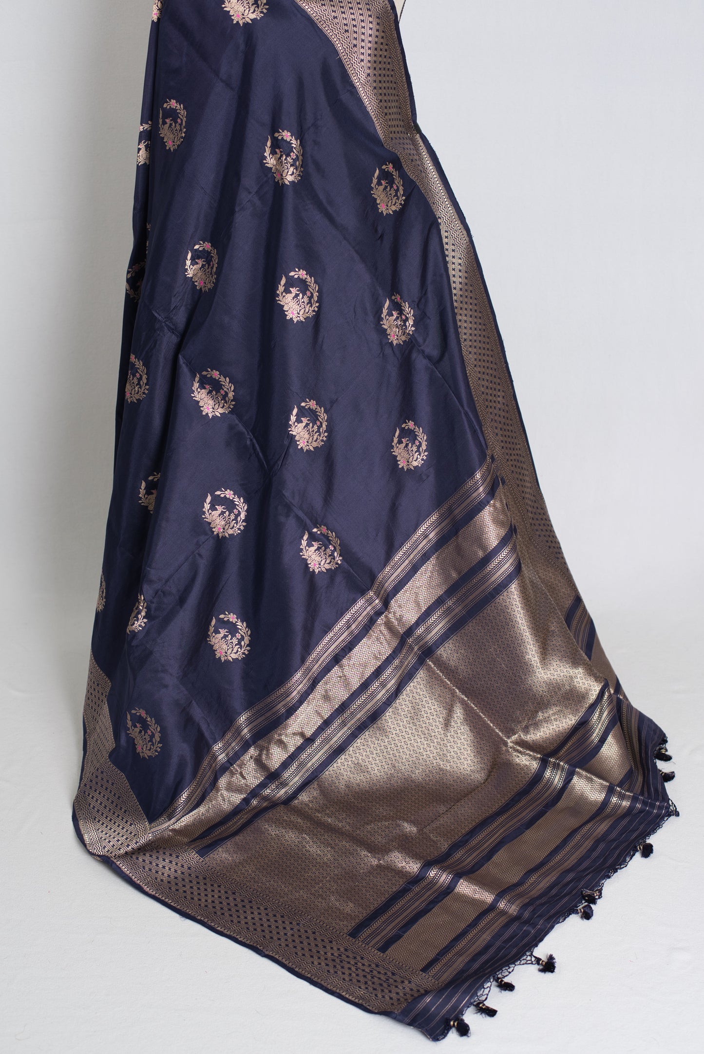 Navy blue and gold saree with intricate patterns on a white background