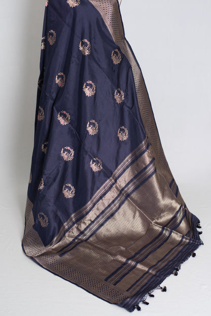 Navy blue and gold saree with intricate patterns on a white background