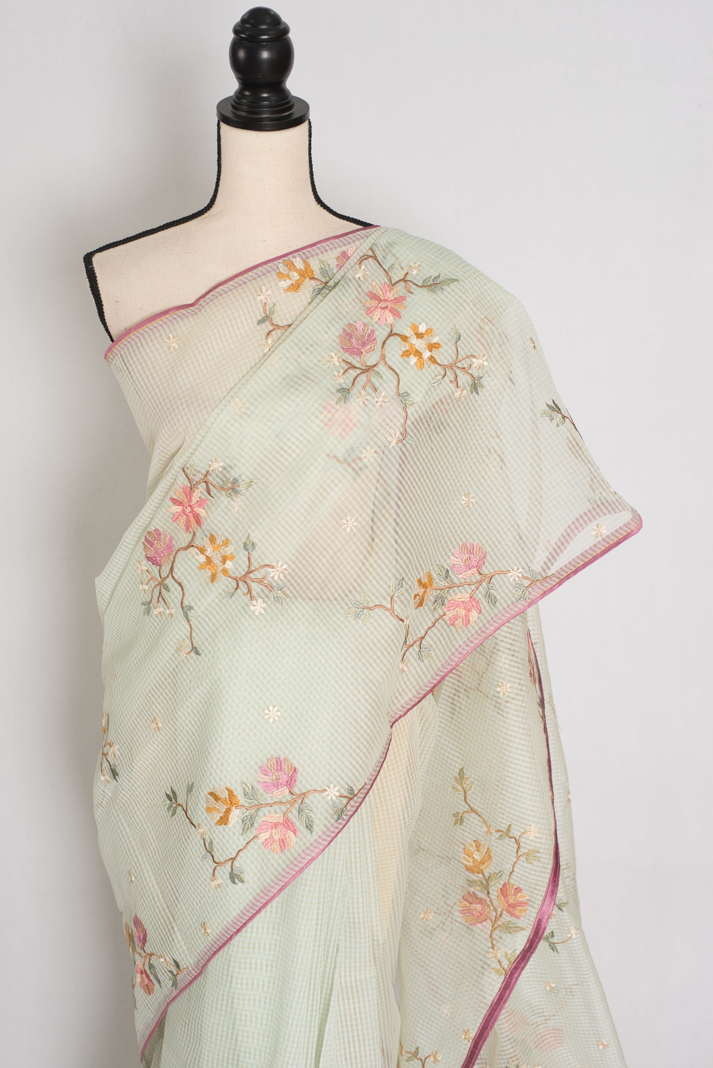 Sea green blended cotton kota saree with floral embroidery, self checks pattern, and pink piping border.