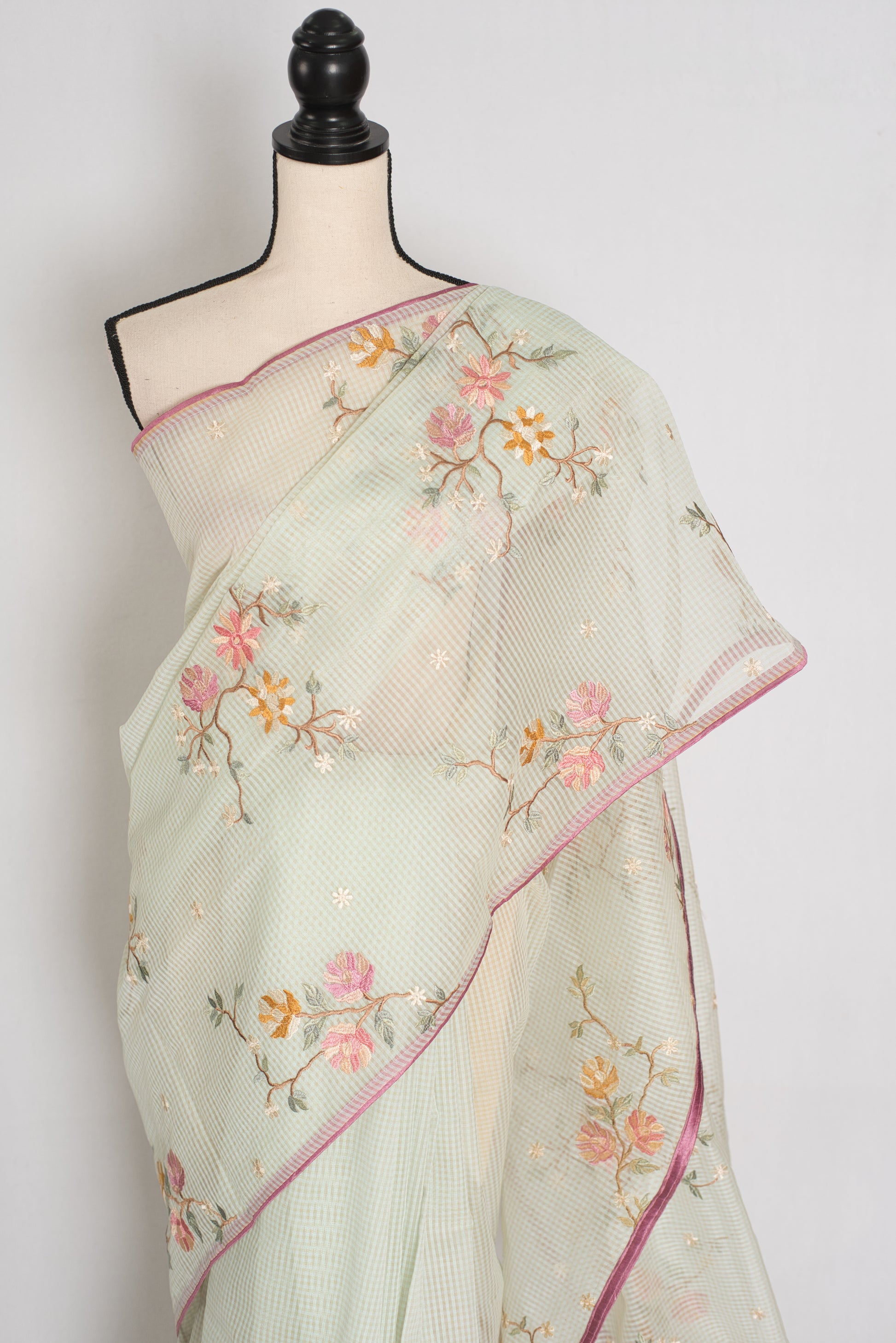 Sea green blended cotton kota saree with floral embroidery, self checks pattern, and pink piping border.