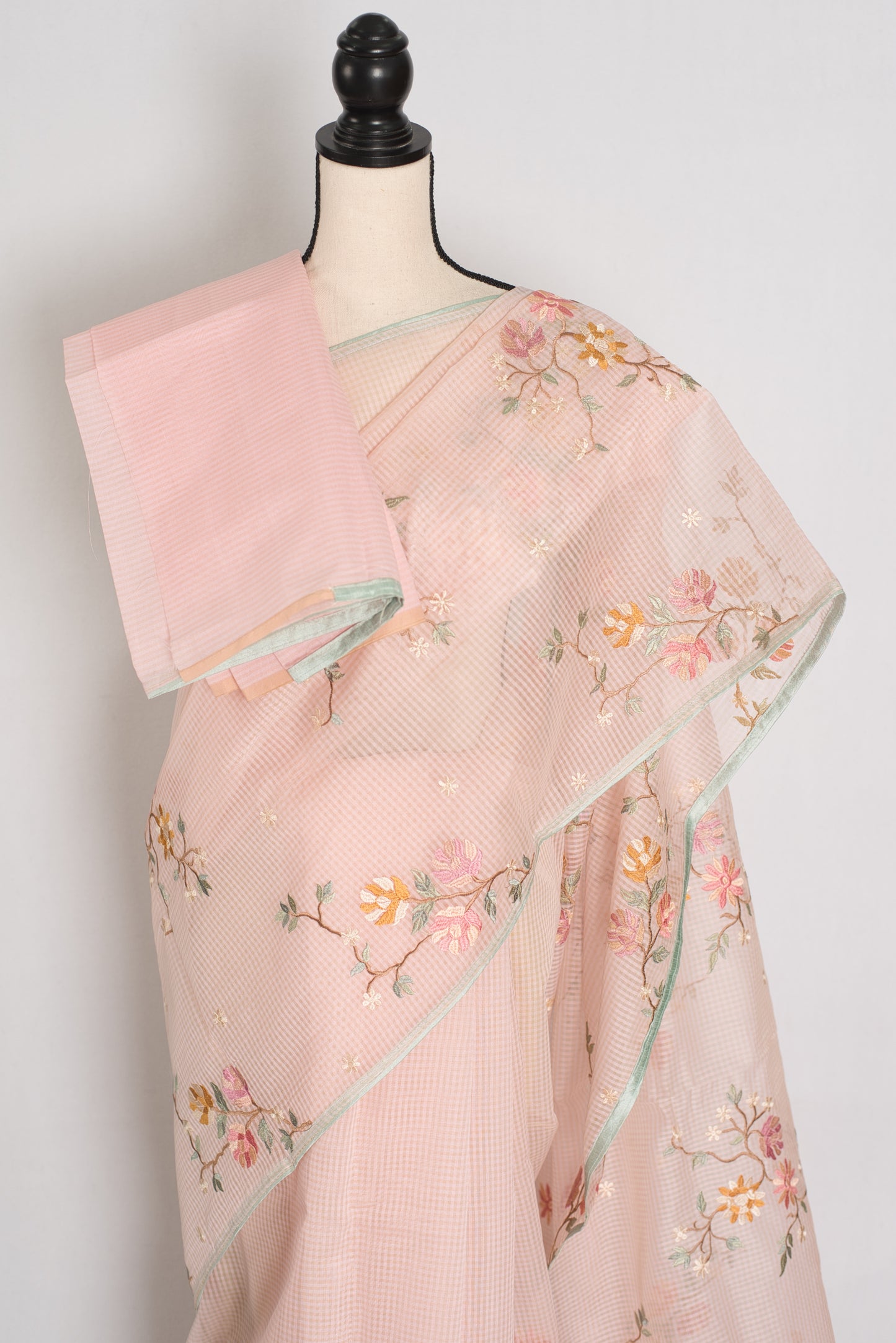 Rohini collection: Pink blended cotton kota saree with floral embroidery, self checks, and sky blue piping border.
