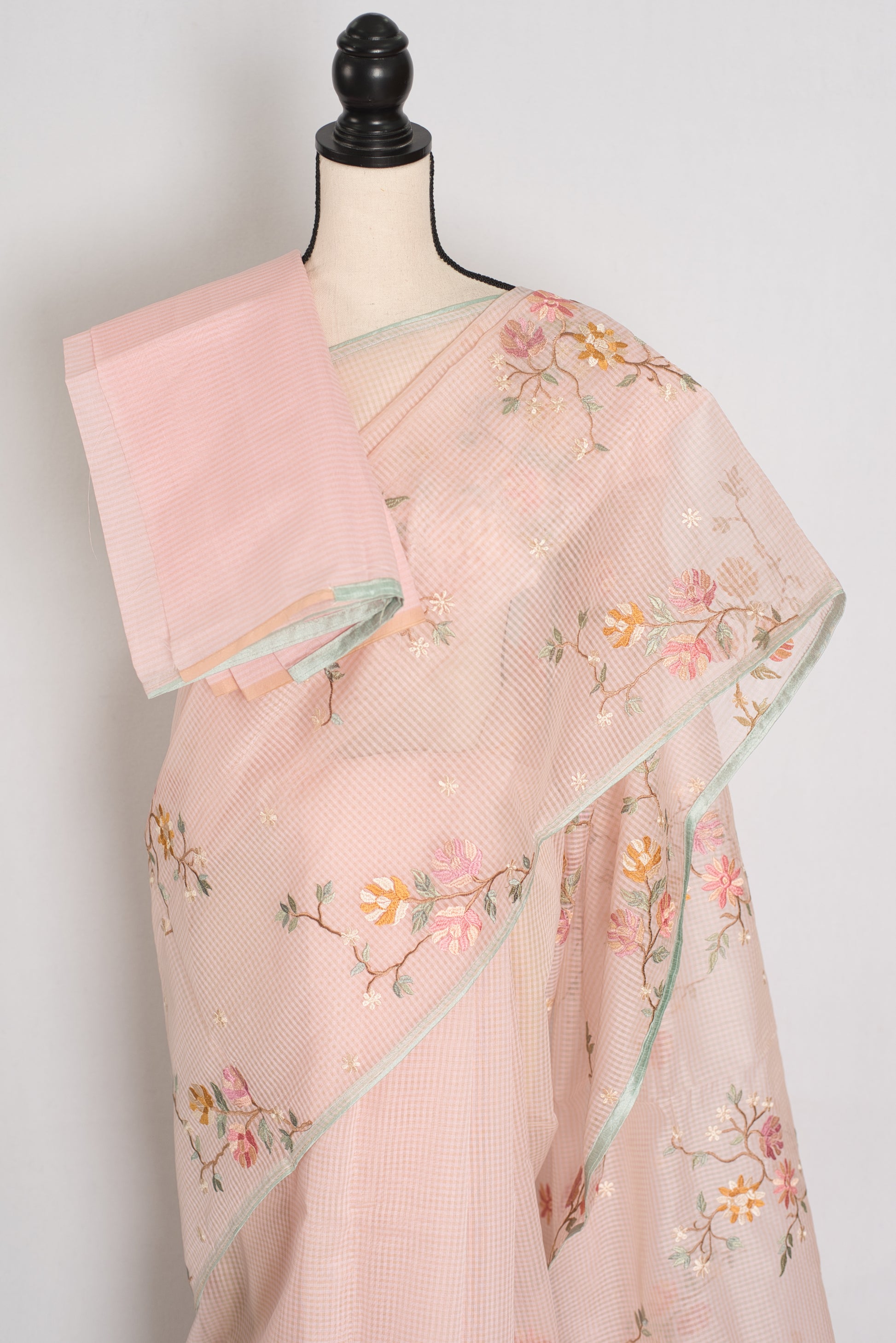 Rohini collection: Pink blended cotton kota saree with floral embroidery, self checks, and sky blue piping border.