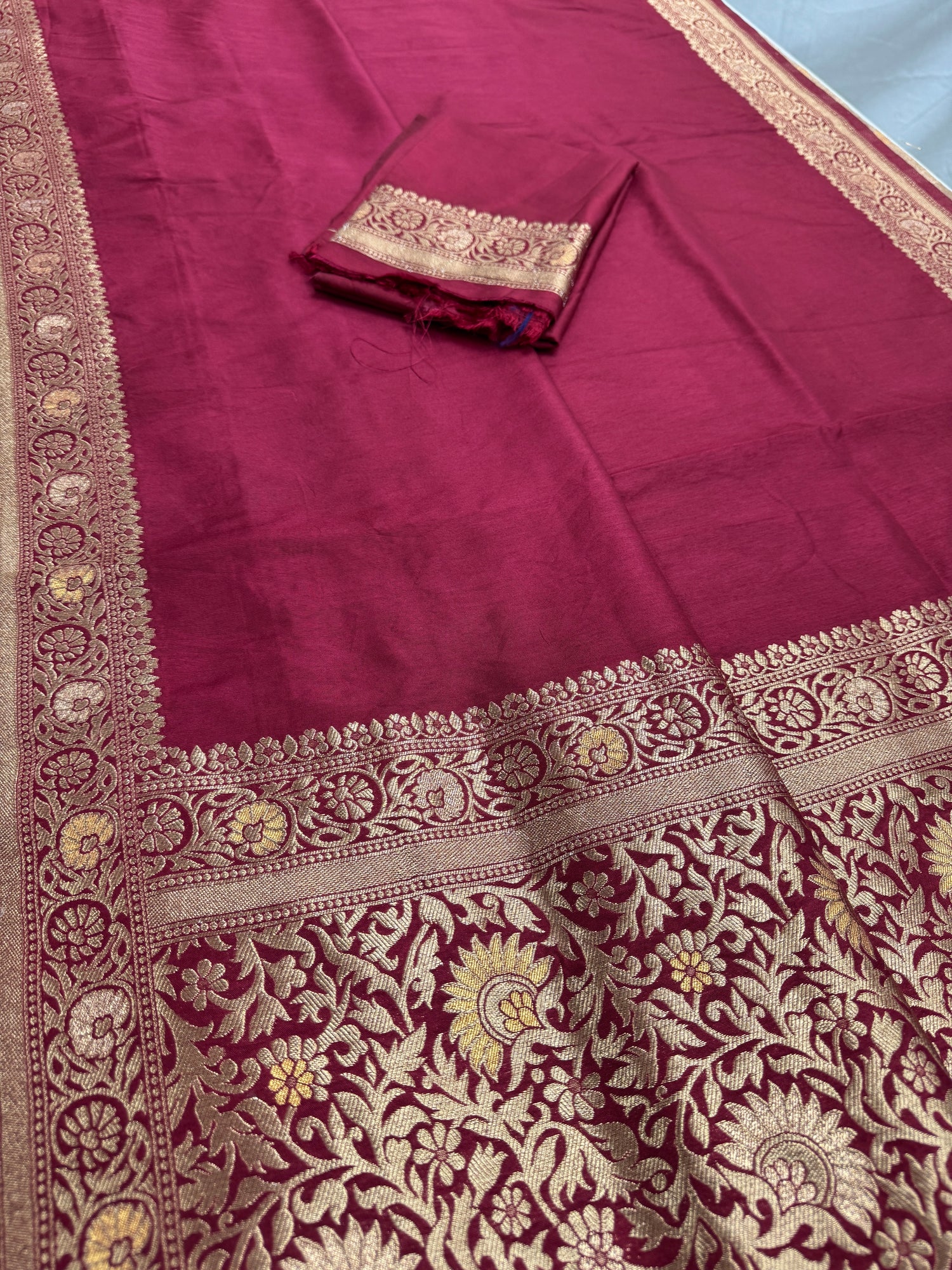 Maroon fabric with intricate gold embroidery
