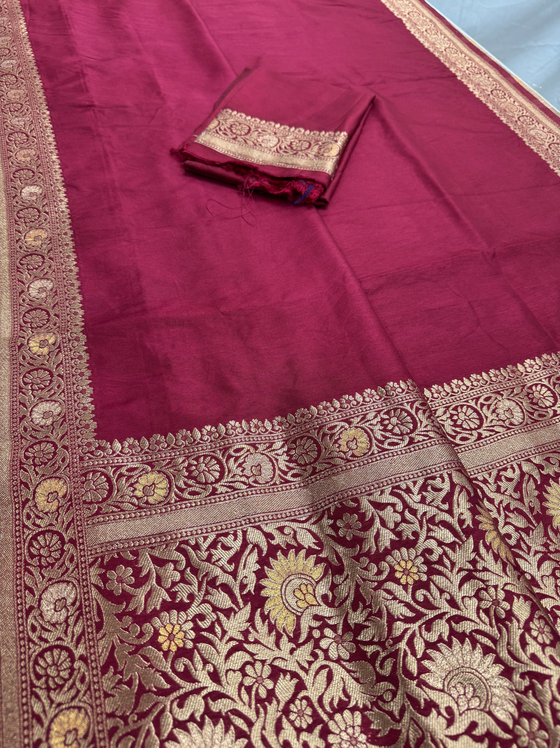 Maroon fabric with intricate gold embroidery