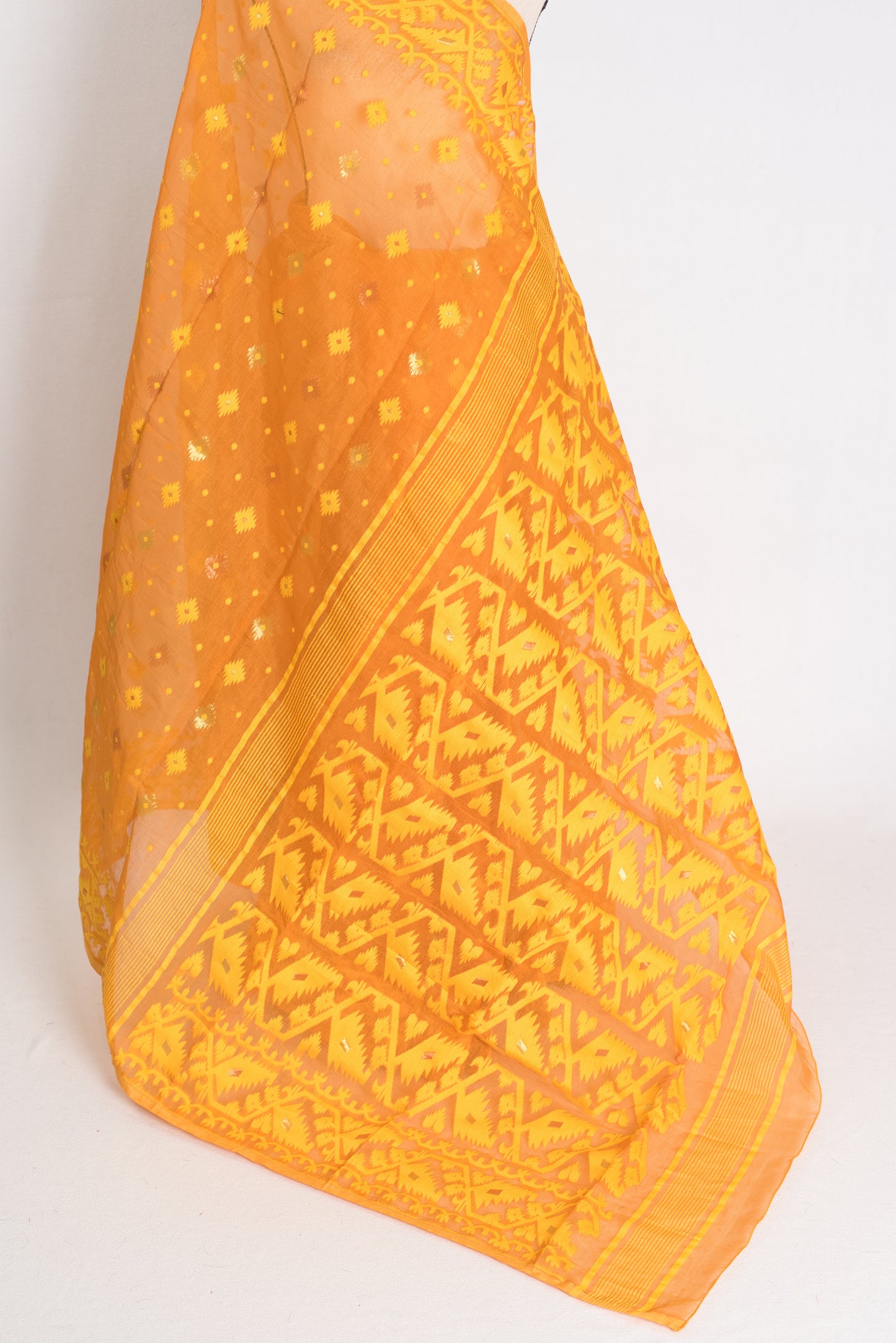 An earthy brown and yellow blended Jamdani saree in soft cotton, featuring traditional Bengali hand-loomed motifs and a sophisticated matte finish.