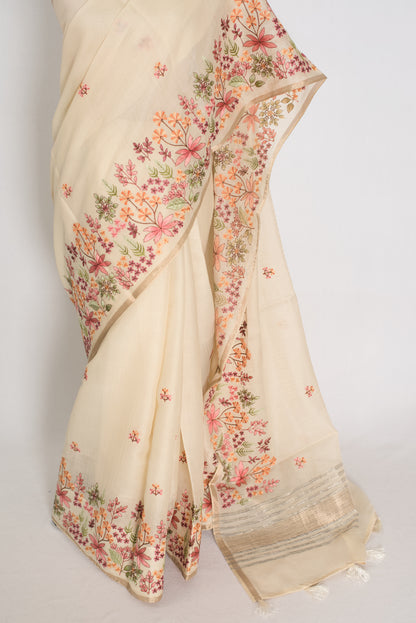 Beige saree with floral patterns on a plain background