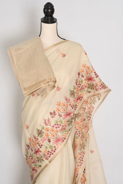 Beige saree with floral embroidery on a mannequin against a white background
