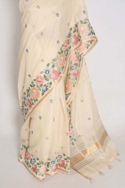 Beige saree with floral patterns on a plain background