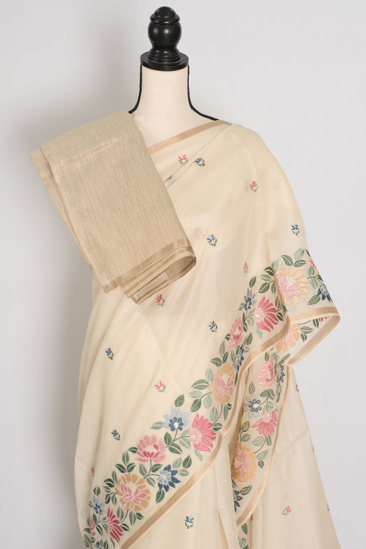 Beige saree with floral patterns on a mannequin against a white background