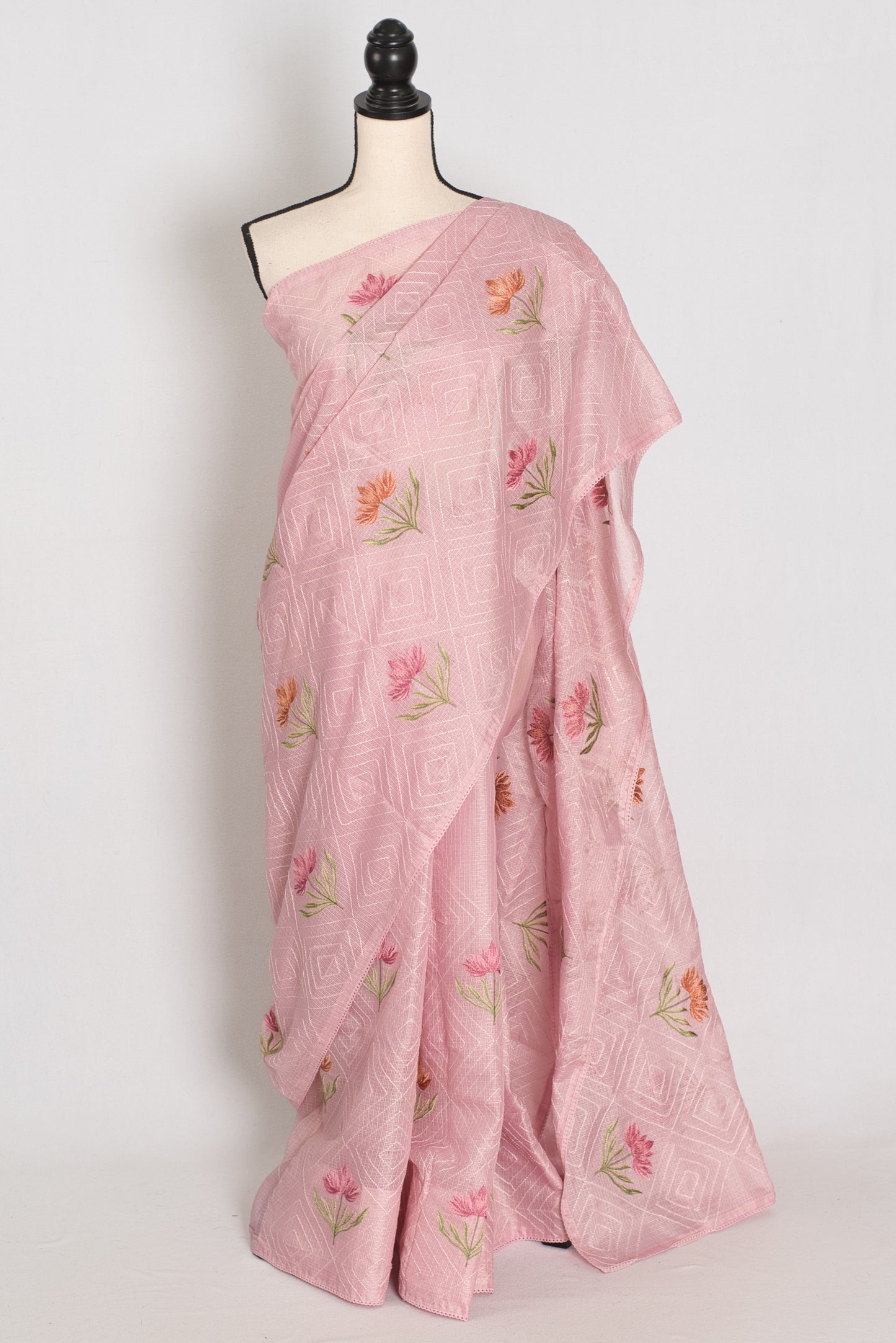 Pink saree with floral patterns on a mannequin against a white background