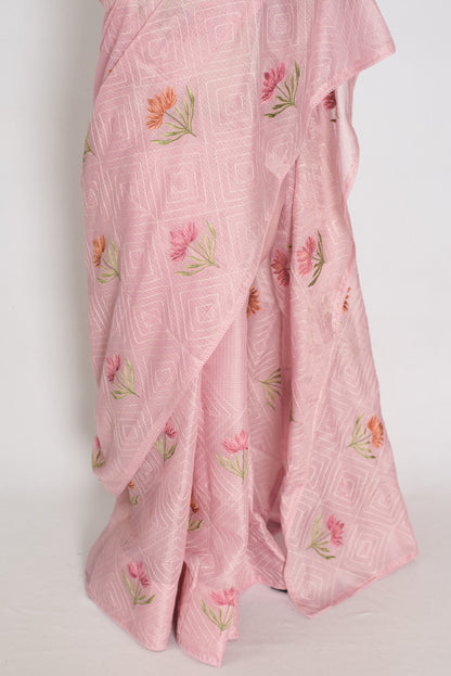 Pink embroidered fabric with floral patterns on a white background