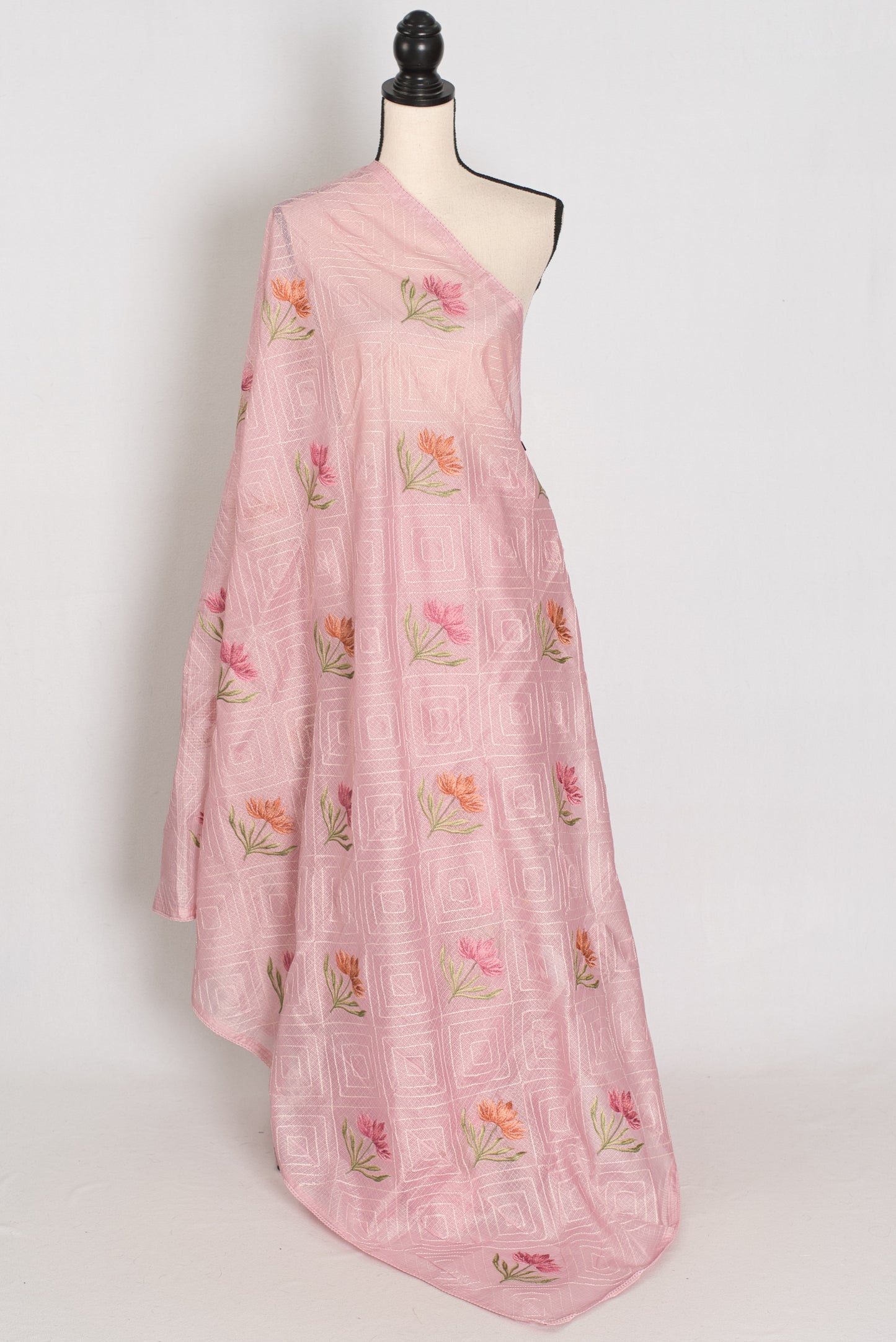 Pink floral dress on a mannequin against a white background
