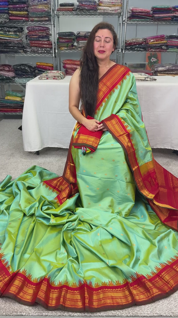 Sea green pure Gadwal silk saree with a rich red and gold zari border.