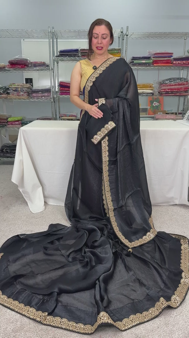 video of product Farah - Designer Glass Tissue Black Partywear Saree with Patched Gold Border from Saree Mandi saree store.